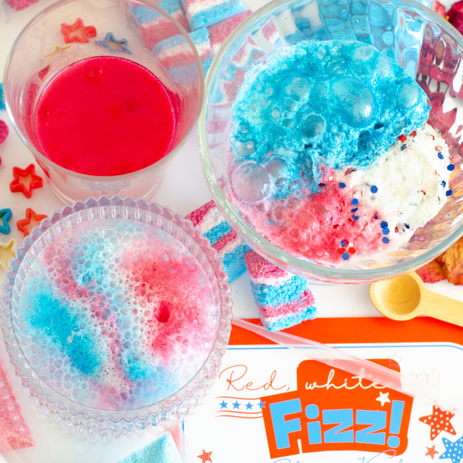 Red ,white and fizz potion kit in action showing red white and blue foaming rocks for creative independence day sensory play.