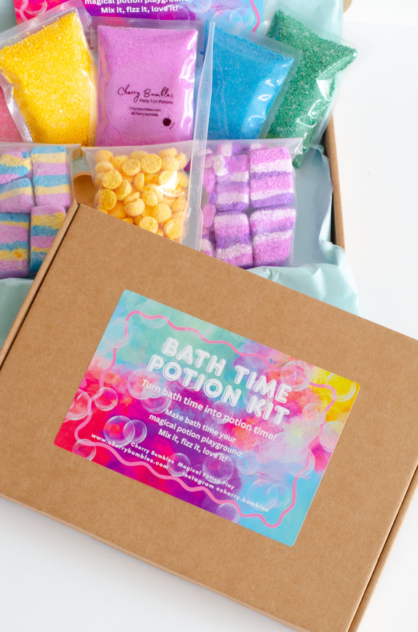 Bath time potion kit with colorful bath bombs and a label on a white background