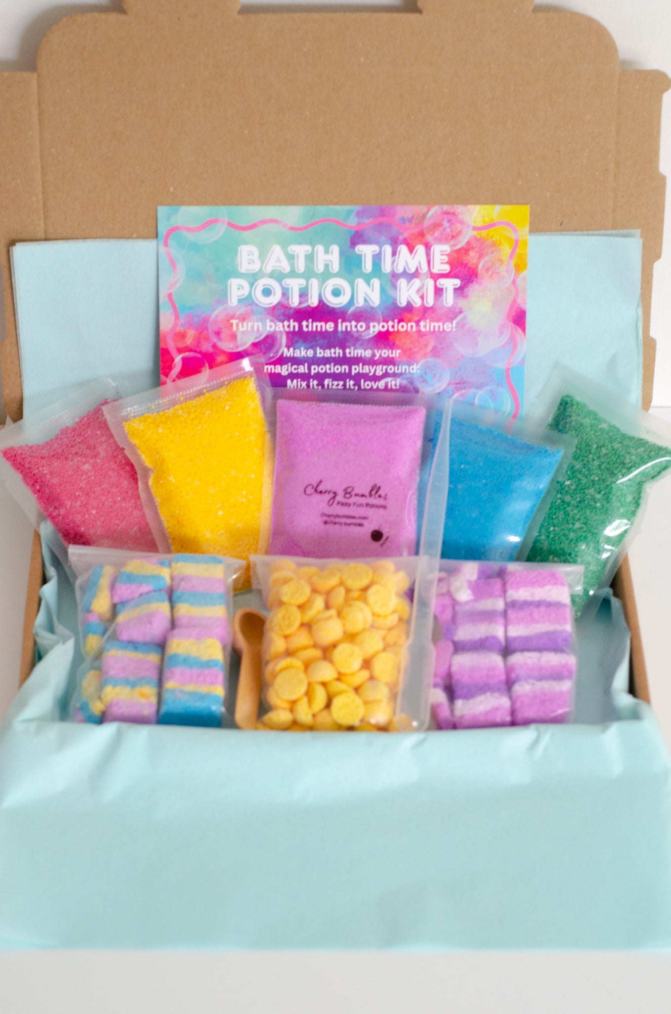 Bath time potion kit with colorful packaging and contents on a light blue background