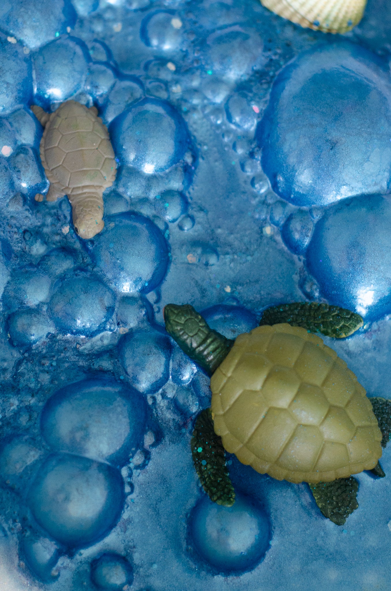 blue fizzy potions being used in children's play, including turtles