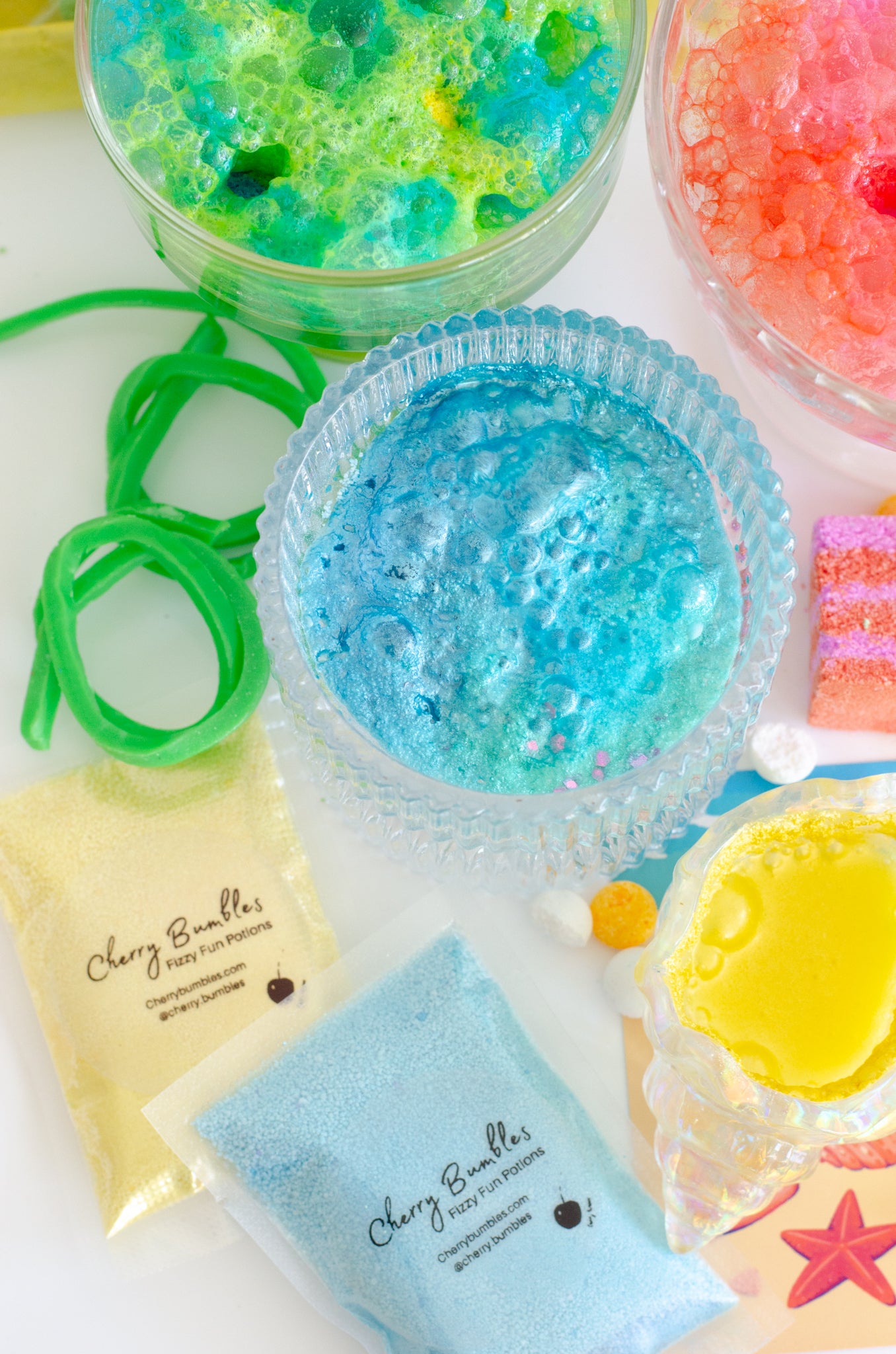 Blue, yellow, green and orange fizzy potion powders by Cherry Bumbles.